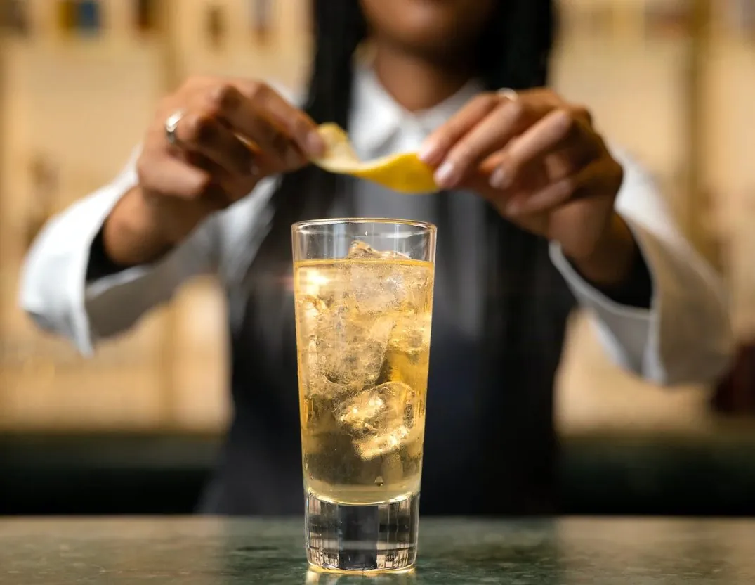Bartender preparing a cocktail garnish